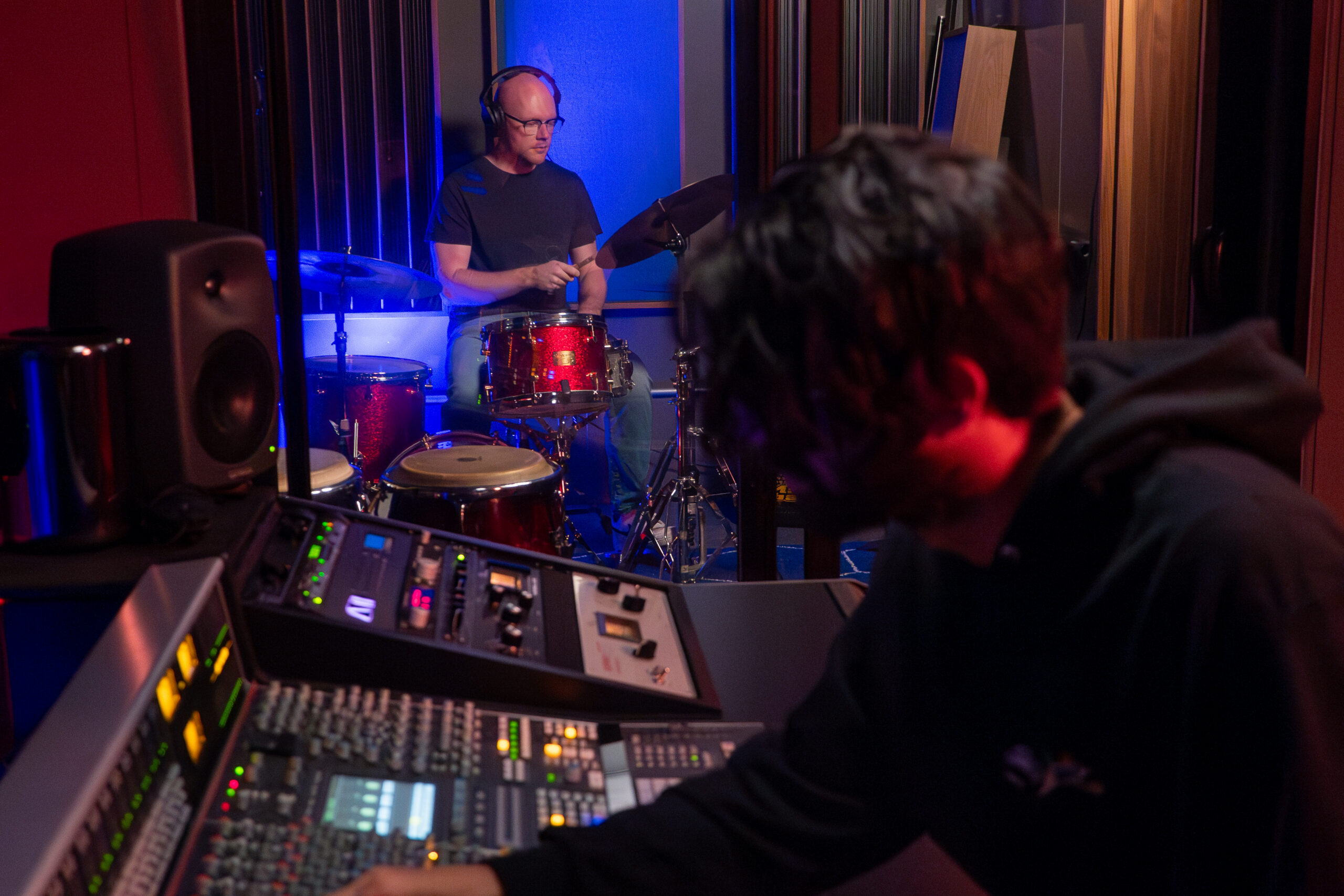 Studio engineer tracking a live drum session at the mixing console inside Sound Collective's NYC recording studio